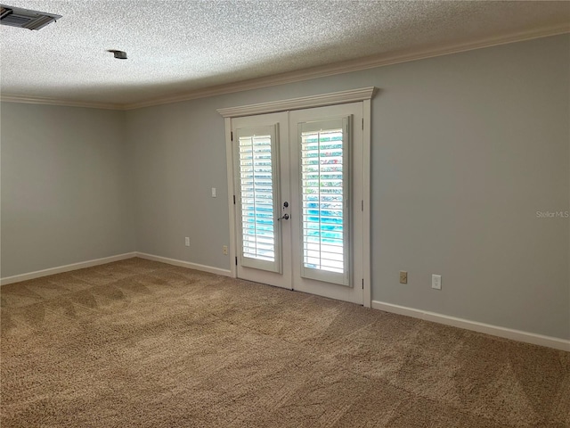 carpeted spare room featuring visible vents, french doors, a wealth of natural light, and ornamental molding