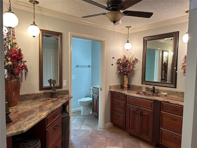 bathroom featuring toilet, crown molding, a textured ceiling, and vanity