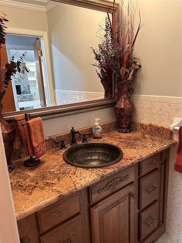 bathroom featuring ornamental molding and vanity