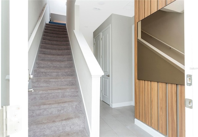 stairway featuring tile patterned floors