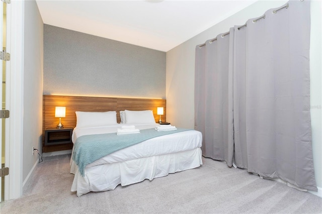 bedroom featuring light colored carpet