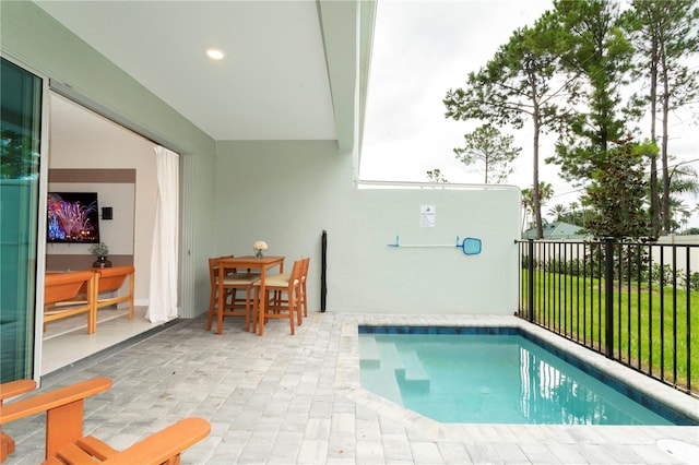 view of swimming pool with a yard