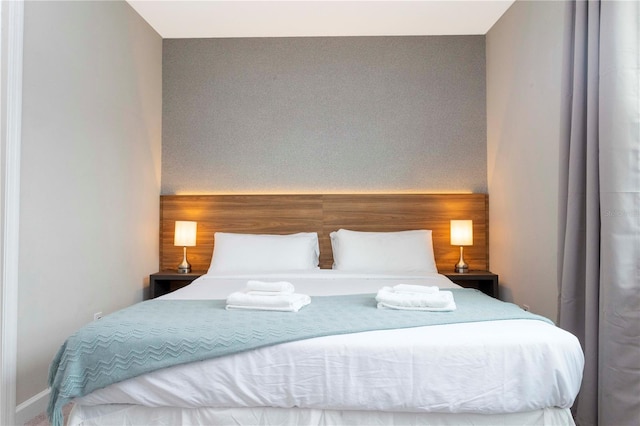 bedroom featuring wooden walls