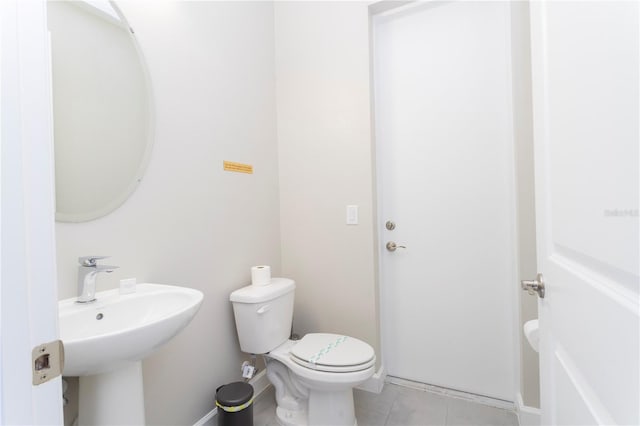 bathroom featuring tile patterned floors and toilet