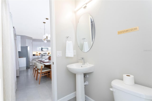 bathroom with toilet and tile patterned floors