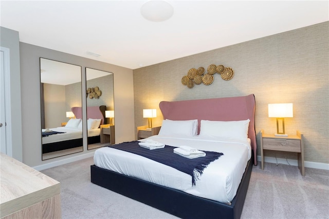 bedroom featuring light colored carpet and a closet