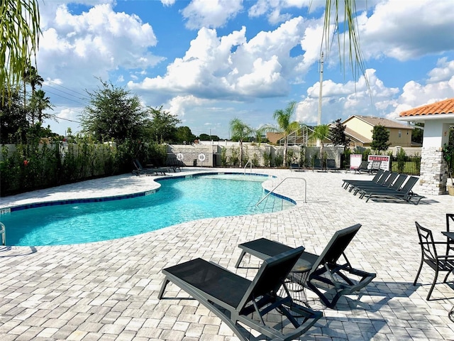 pool featuring a patio area and fence