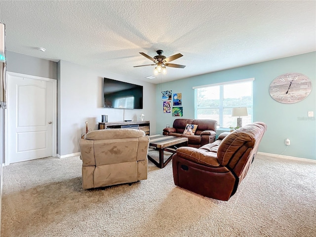 living room featuring a textured ceiling, ceiling fan, and light colored carpet