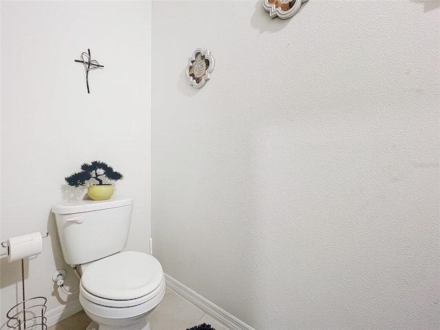 bathroom featuring tile patterned flooring and toilet