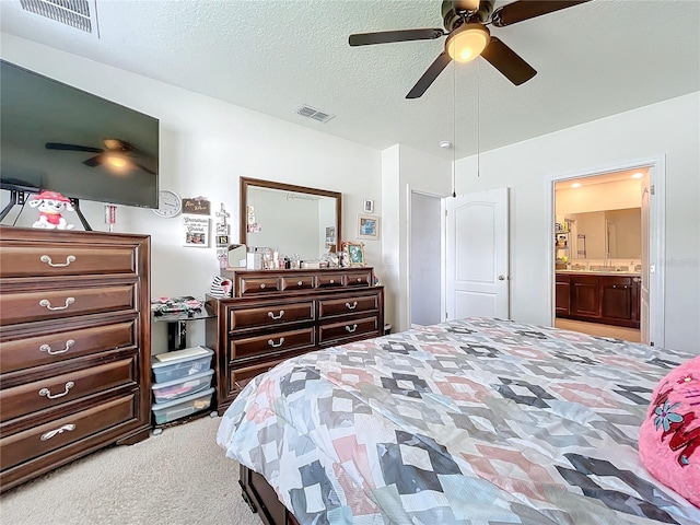 carpeted bedroom featuring ceiling fan, a textured ceiling, and connected bathroom