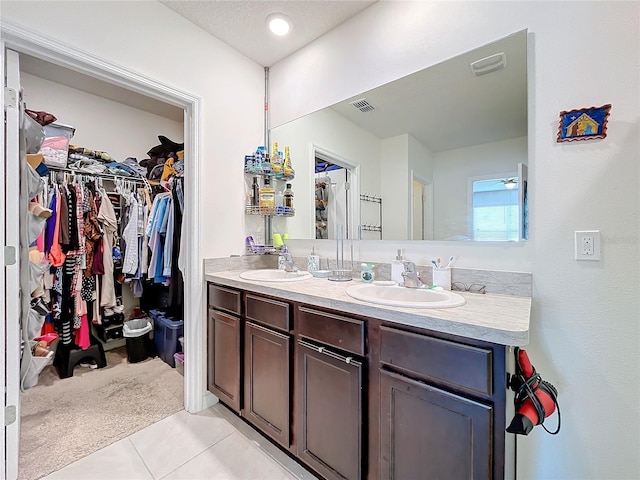 bathroom with tile patterned flooring and vanity