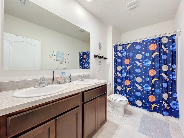 bathroom with a textured ceiling, a shower with curtain, tile patterned floors, vanity, and toilet