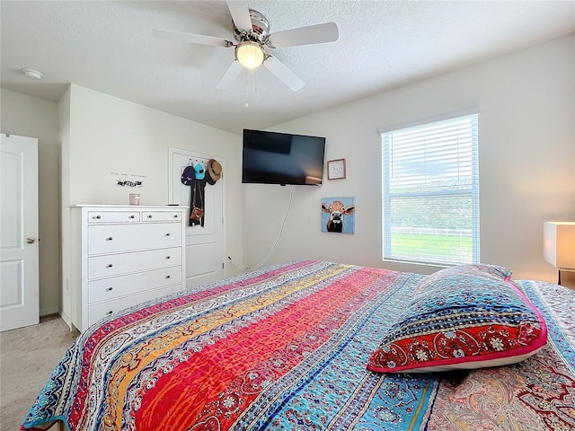 bedroom with a textured ceiling and ceiling fan