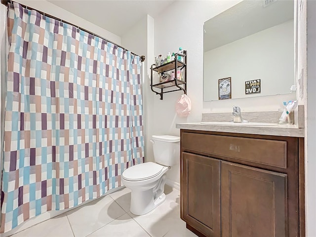 bathroom featuring walk in shower, vanity, toilet, and tile patterned floors