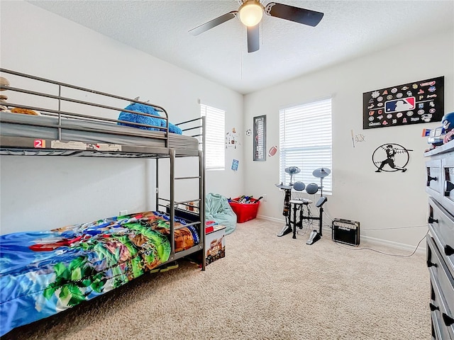 bedroom with carpet floors, a textured ceiling, and ceiling fan