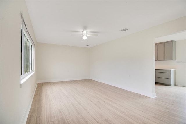 spare room featuring ceiling fan and light wood-type flooring