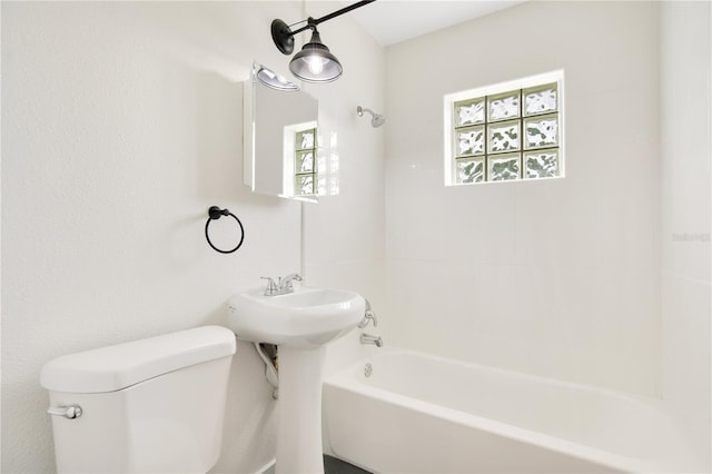 bathroom with toilet and tub / shower combination