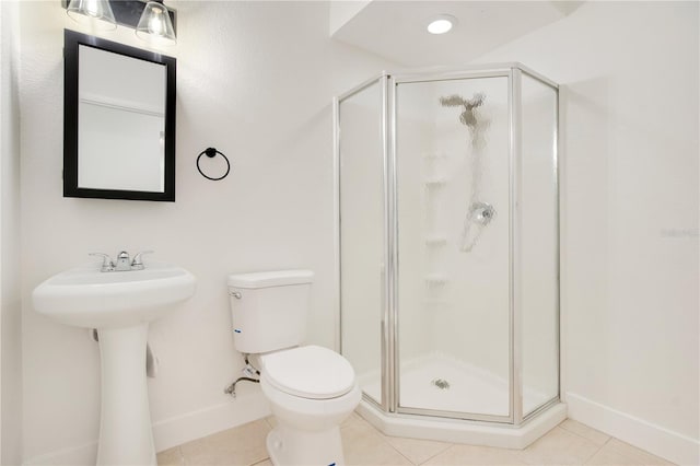 bathroom with toilet, tile patterned floors, a shower with door, and sink