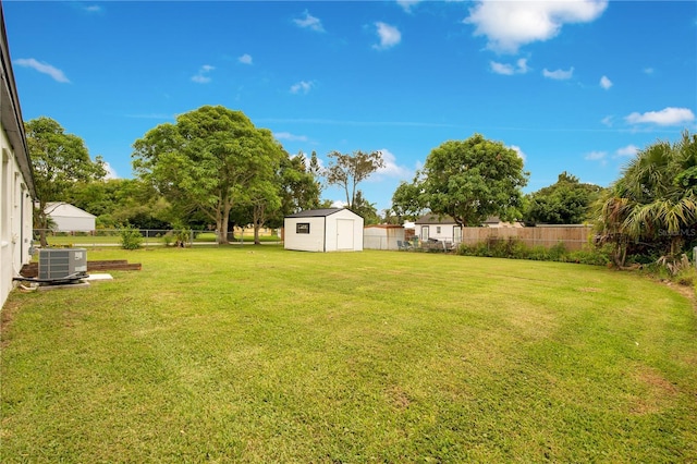 view of yard with a shed and central AC unit