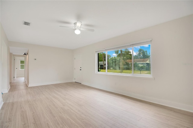 unfurnished room with ceiling fan and light wood-type flooring