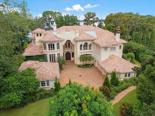 9164 Point Cypress Dr, Orlando, FL 32836 - mediterranean / spanish house with a chimney, stucco siding, and a tile roof