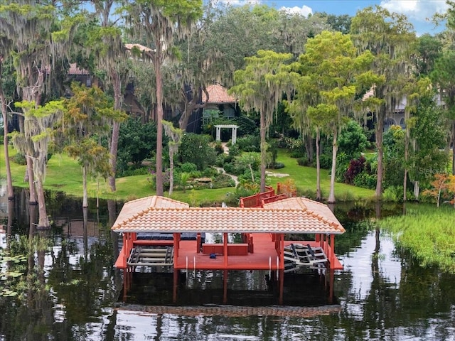 dock area featuring a water view and a yard