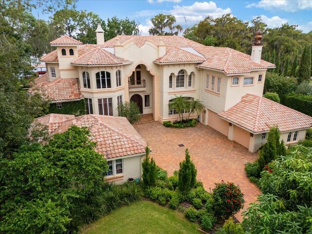 9164 Point Cypress Dr, Orlando, FL 32836 - rear view of house with a garage, stucco siding, decorative driveway, and a tile roof