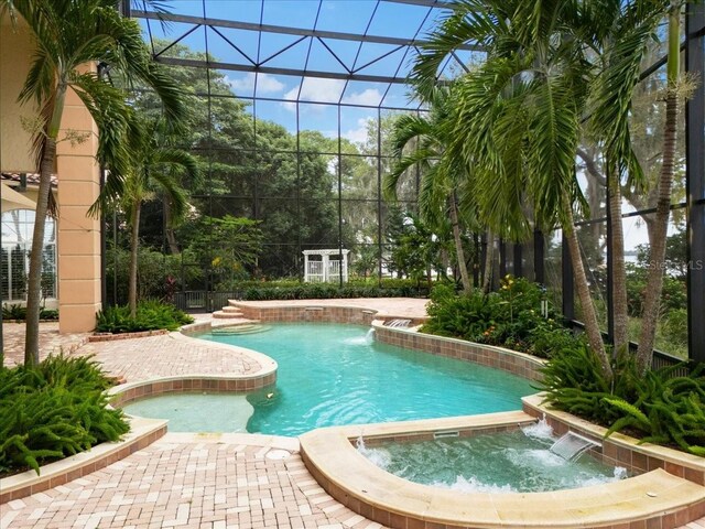9164 Point Cypress Dr, Orlando, FL 32836 - view of pool with a pool with connected hot tub and glass enclosure