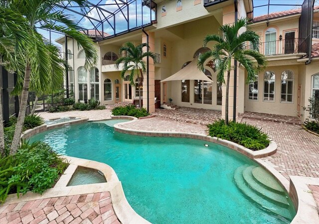 9164 Point Cypress Dr, Orlando, FL 32836 - view of swimming pool with a pool with connected hot tub and a lanai