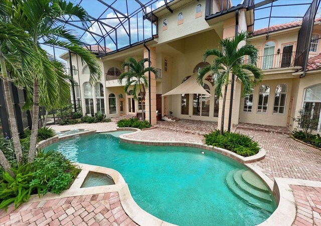 9164 Point Cypress Dr, Orlando, FL 32836 - view of pool with a pool with connected hot tub, glass enclosure, and a patio area