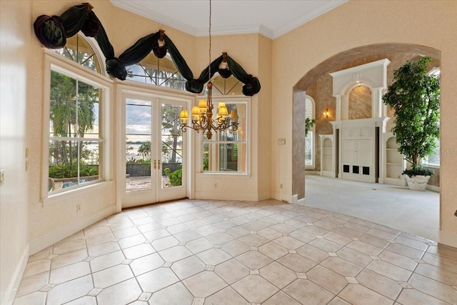 unfurnished dining area featuring crown molding, light colored carpet, and a notable chandelier