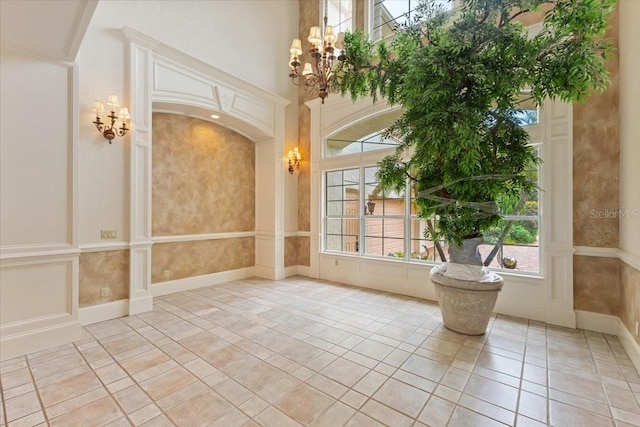 entrance foyer featuring a high ceiling and a chandelier