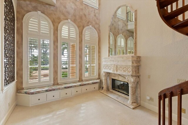 9164 Point Cypress Dr, Orlando, FL 32836 - unfurnished living room with carpet flooring and a glass covered fireplace