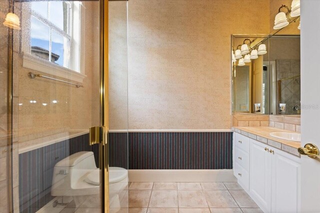 9164 Point Cypress Dr, Orlando, FL 32836 - bathroom featuring vanity, wainscoting, a stall shower, and tile patterned floors