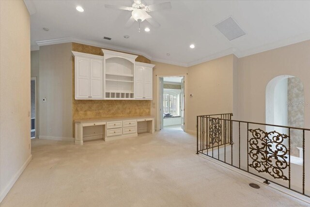 9164 Point Cypress Dr, Orlando, FL 32836 - unfurnished room with crown molding, light carpet, built in desk, ceiling fan, and recessed lighting