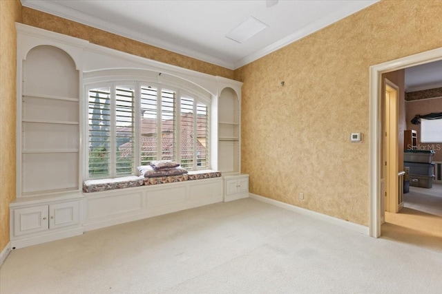 empty room with ornamental molding and light carpet