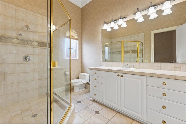 bathroom featuring vanity, tile patterned flooring, toilet, and an enclosed shower