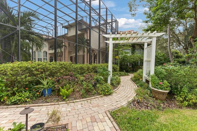 view of yard with a lanai and a pergola