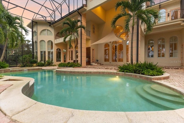 view of swimming pool featuring a patio and french doors