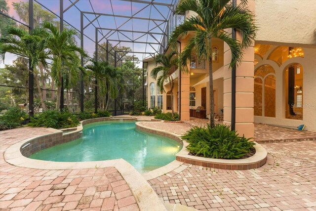 9164 Point Cypress Dr, Orlando, FL 32836 - outdoor pool featuring a patio and glass enclosure