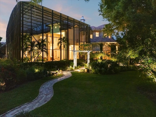 back house at dusk with a yard