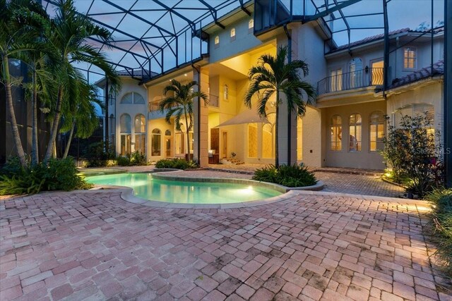 9164 Point Cypress Dr, Orlando, FL 32836 - pool at dusk featuring a patio area, a lanai, and an outdoor pool
