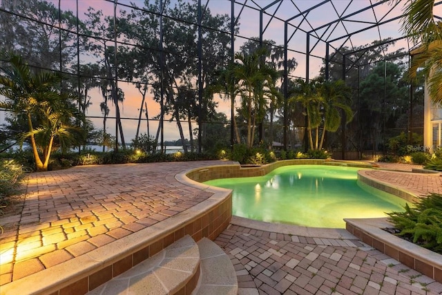 pool at dusk with a patio