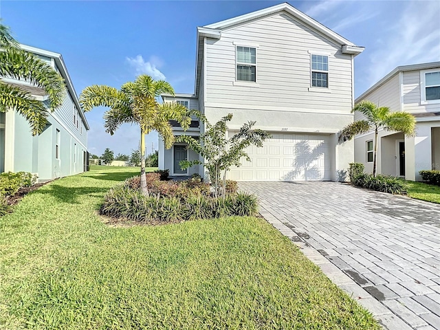 view of front of home featuring a garage and a front lawn