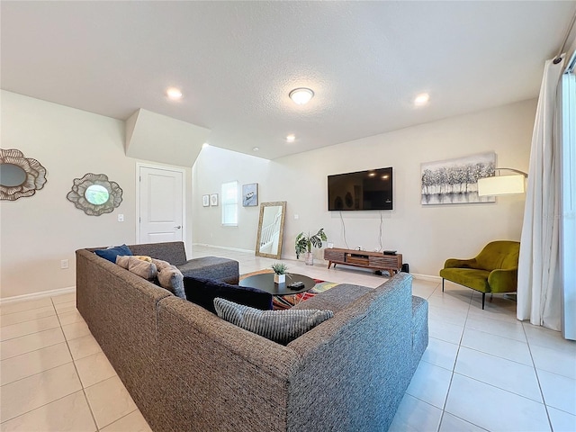 living room featuring a textured ceiling and light tile patterned floors