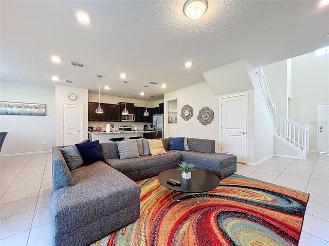 tiled living room with a textured ceiling