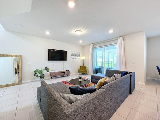 living room with a textured ceiling and light tile patterned flooring