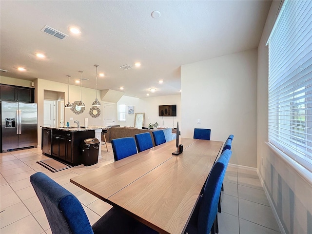 dining room featuring light tile patterned flooring and sink