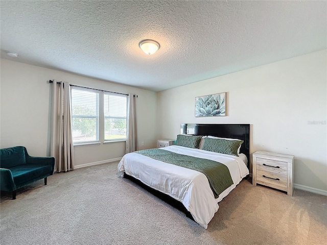 bedroom with a textured ceiling and carpet floors