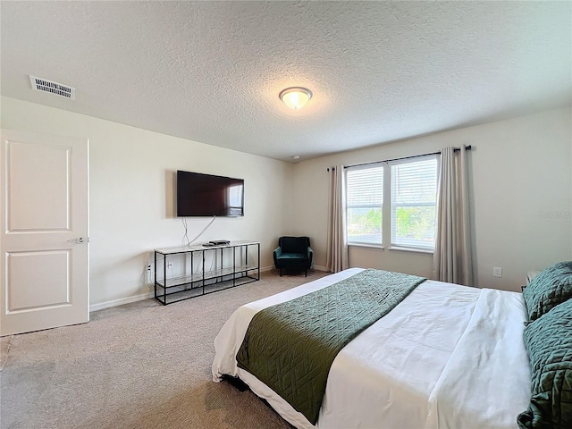 bedroom featuring a textured ceiling and carpet flooring